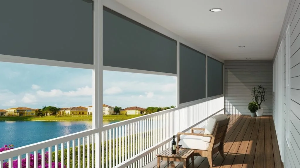 Exterior channel-guided shades providing sun control on a waterfront porch.